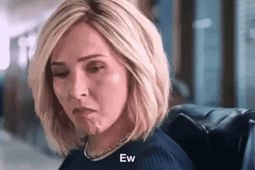 Woman Sitting In Chair With Eyes Closed Making Face GIF