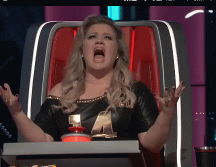 Woman Sitting in Chair With Mouth Wide Open