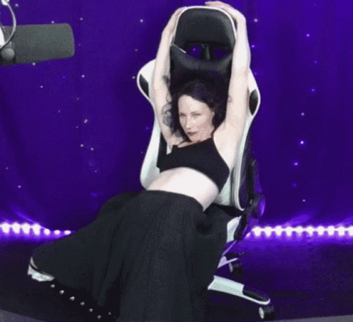Woman Sitting in Chair with Outstretched Arms