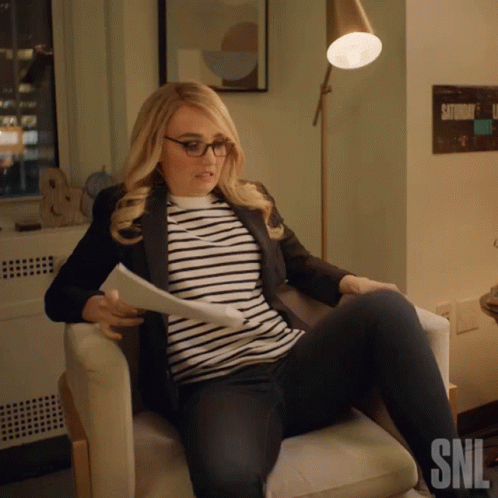 Woman Sitting in Chair with SNL Logo