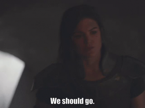 Woman Sitting in Dark Room Saying We Should Go