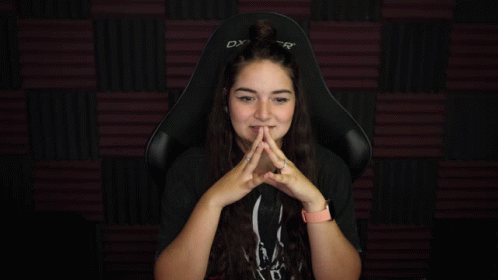 Woman Sitting in DX Gaming Chair With Hands Up