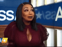 Woman Sitting In Front Of Blue Sign Saying SS GIF