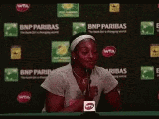 Woman Sitting in Front of BNP Paribas Sign
