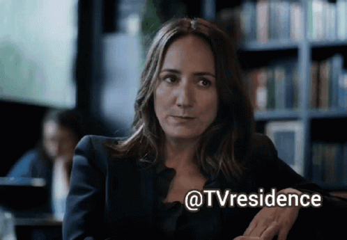 Woman Sitting in Front of Bookshelf @tvresidence