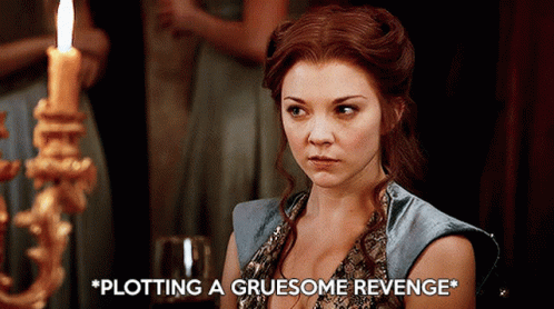 Woman Sitting In Front Of Candle Plotting A Gruesome Revenge GIF