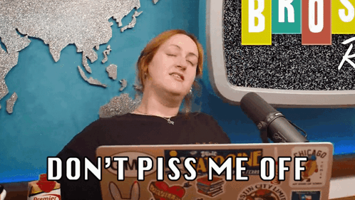 Woman Sitting in Front of Do Not Piss Me Off Laptop