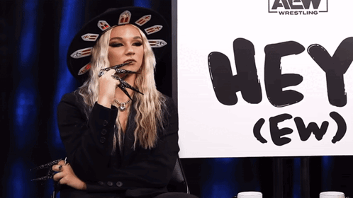 Woman Sitting in Front of Hey Sign