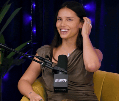 Woman Sitting in Front of Microphone Saying Variety