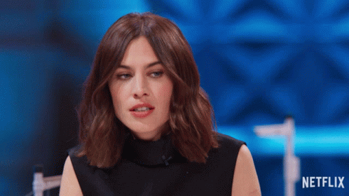 Woman Sitting In Front Of Netflix Sign GIF