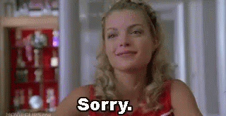 Woman Sitting In Front Of Shelf Saying Sorry GIF