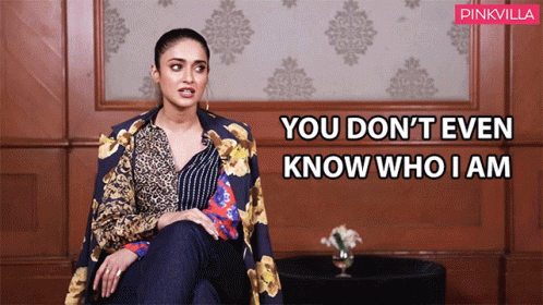 Woman Sitting in Front of Wall You Don't Even Know Who I Am