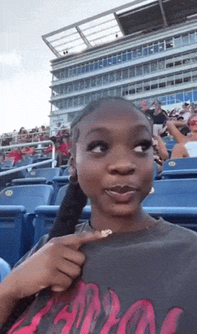 Woman Sitting in Stadium Wearing Apollo Shirt