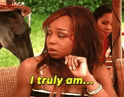 Woman Sitting in Wicker Chair Says I Truly Am