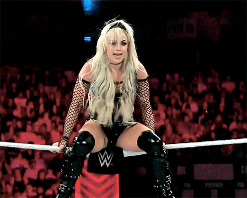 Woman Sitting In Wrestling Ring With W Logo GIF