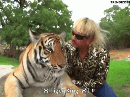 Woman Sitting Next to Tiger With Tiger King