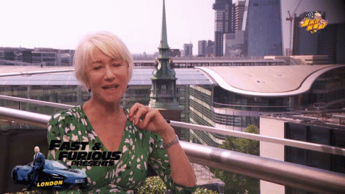 Woman Sitting on Balcony Wearing Green Shirt