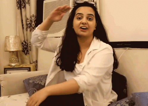 Woman Sitting on Bed Arm Outstretched