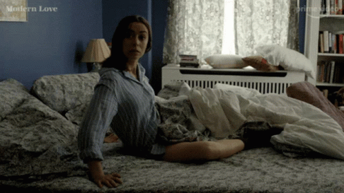 Woman Sitting on Bed With Modern Love