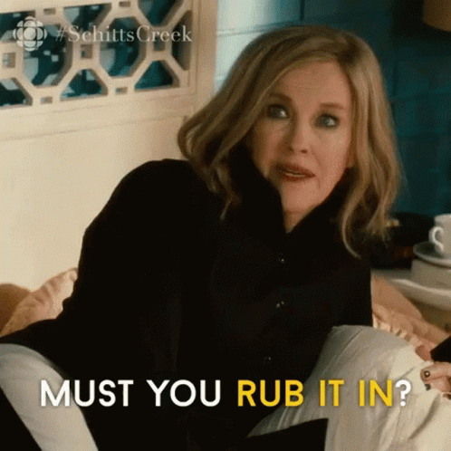 Woman Sitting On Bed With Pillow Must You Rub It In GIF