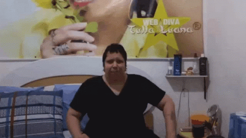 Woman Sitting on Bed with Web Diva Sign