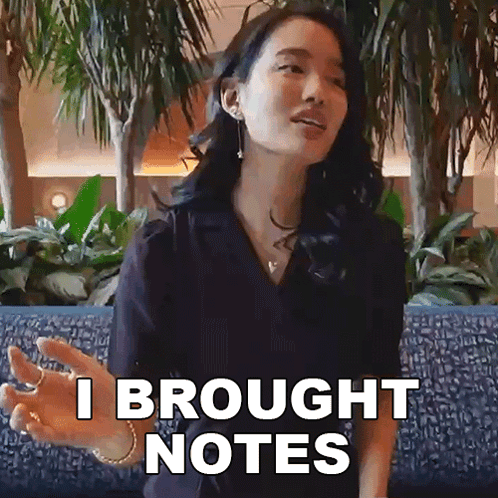 Woman Sitting on Blue Couch Saying I Brought Notes