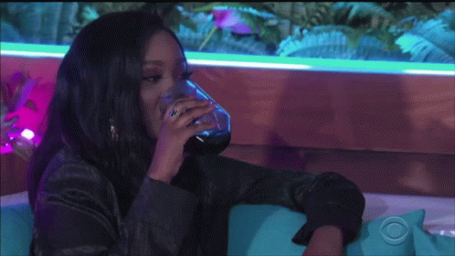 Woman Sitting On Couch Drinking Water GIF