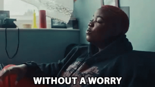 Woman Sitting On Couch Eyes Closed Without A Worry GIF