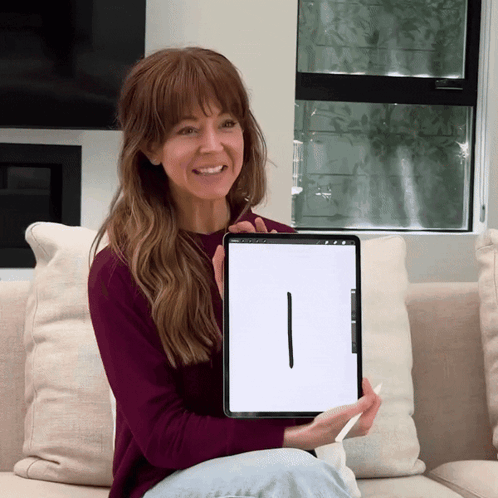 Woman Sitting on Couch Holding iPad