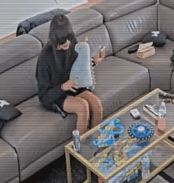 Woman Sitting On Couch Holding Toy GIF