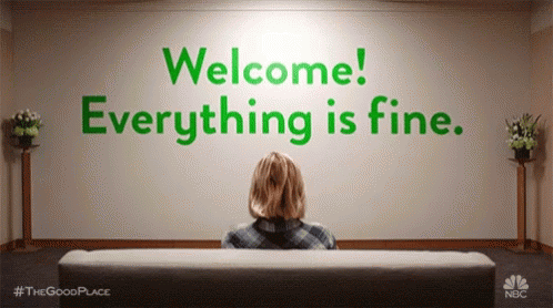 Woman Sitting On Couch In Front Of Welcome Everything Is Fine Wall GIF