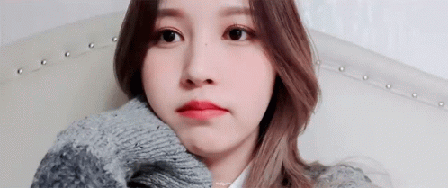 Woman Sitting On Couch In Sweater GIF