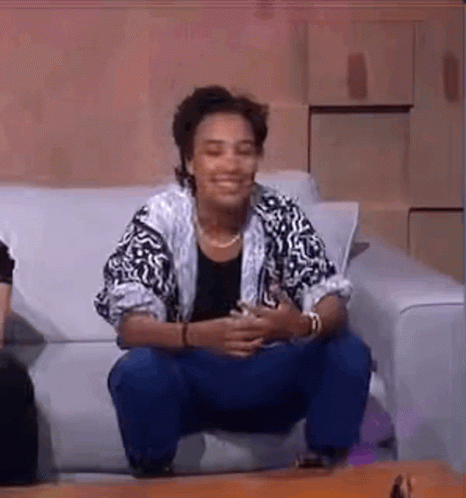 Woman Sitting On Couch Legs Crossed GIF