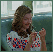 Woman Sitting on Couch Looking at Phone
