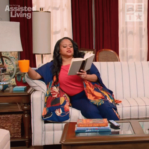 Woman Sitting on Couch Reading Pieces of Our Soul