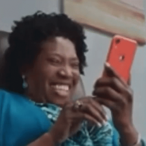 Woman Sitting on Couch Smiling at Phone