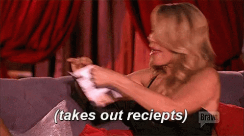 Woman Sitting on Couch Takes Out Receipts