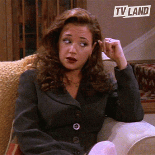 Woman Sitting on Couch Under TV Land Logo