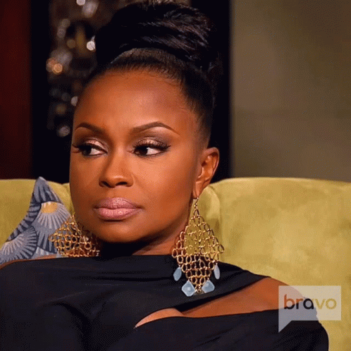 Woman Sitting On Couch With Bravo Logo GIF
