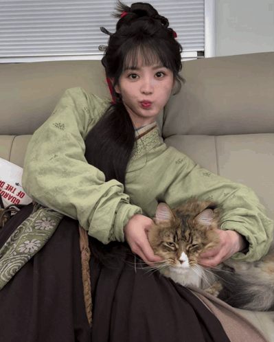 Woman Sitting on Couch With Cat and Bag Saying Road of the Dead
