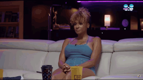 Woman Sitting on Couch With Coffee and Popcorn