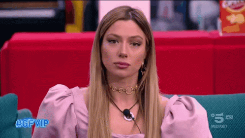 Woman Sitting on Couch With #Gfvip on Bottom Left