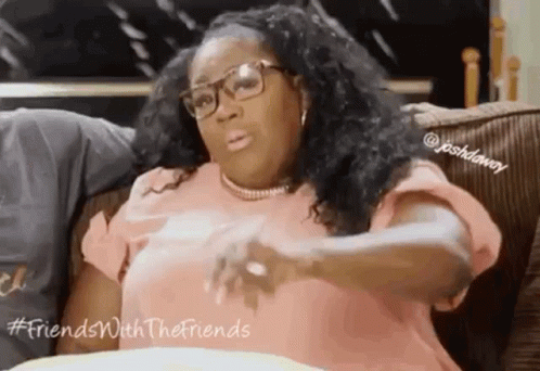 Woman Sitting On Couch With Glasses And Necklace GIF