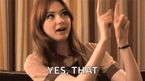 Woman Sitting on Couch With Hands Up