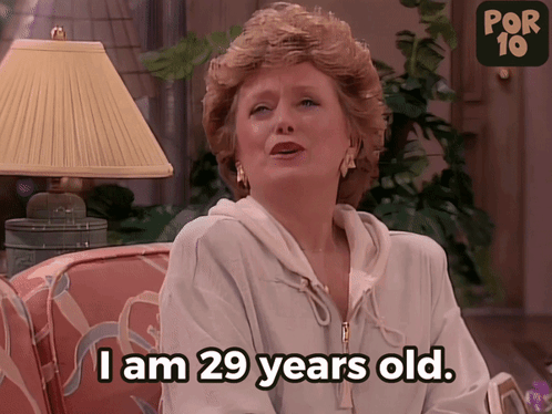 Woman Sitting on Couch With I Am 29 Years Old Text