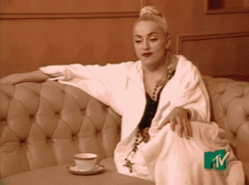 Woman Sitting on Couch With MTV Logo on Feet
