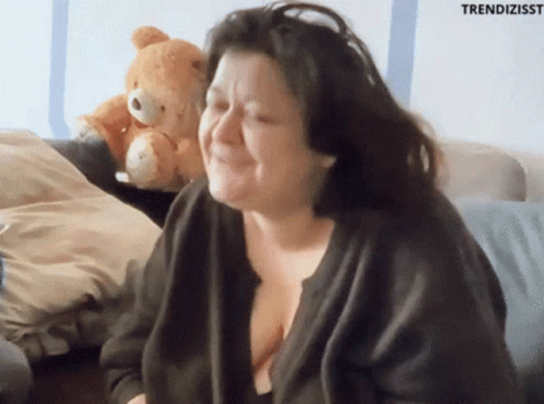 Woman Sitting on Couch With Teddy Bear and Trendizisst