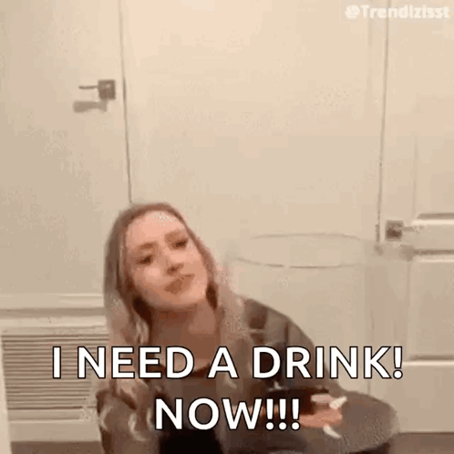 Woman Sitting on Floor Holding Wine Saying I Need a Drink Now