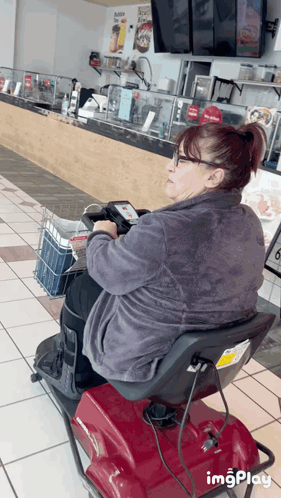 Woman Sitting on Mobility Scooter in Restaurant