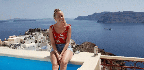 Woman Sitting On Poolside In Greece GIF